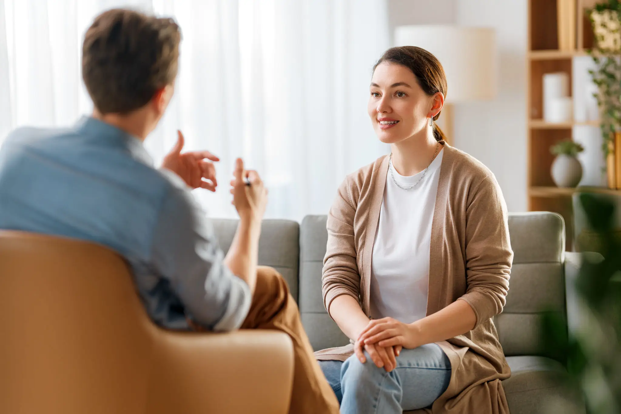 Two people having a conversation on couch.