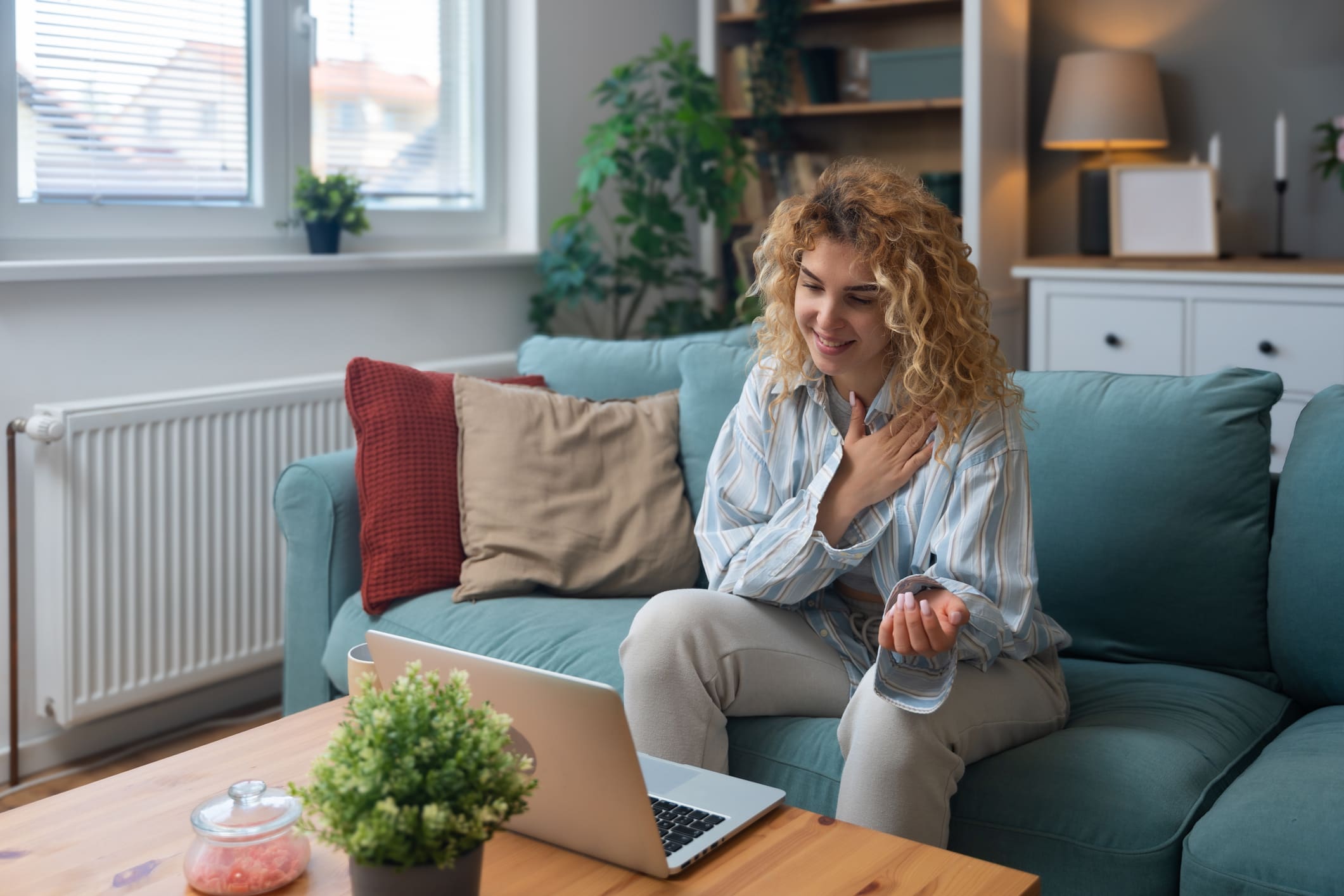 Woman video chatting on a laptop.
